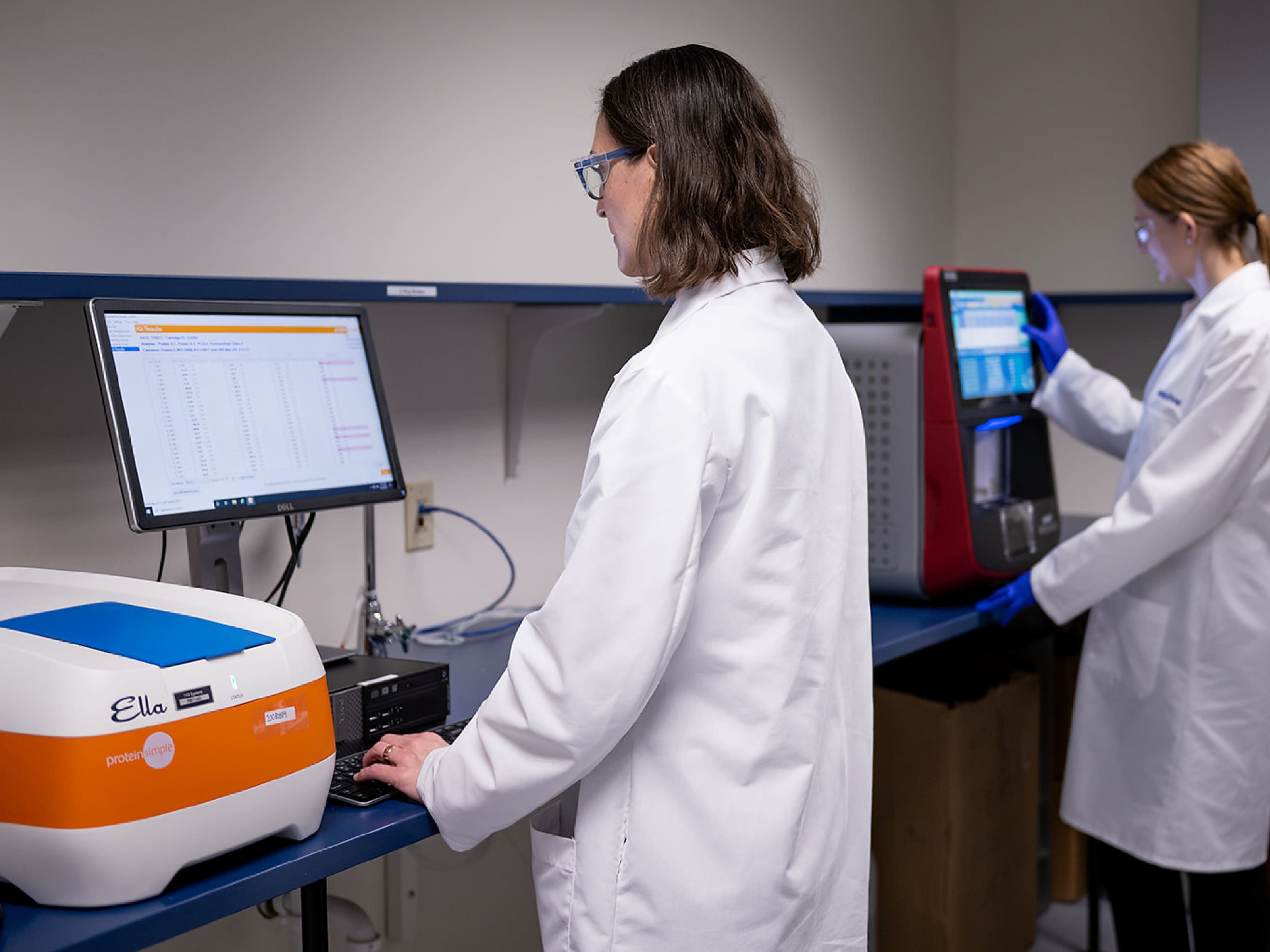 Scientists running automated immunoassays on Ella™ and Luminex® xMAP™ INTELLIFLEX